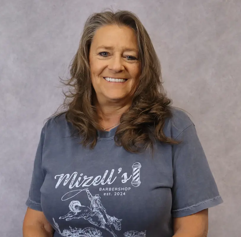 Michelle Graham: Headshot of Michelle Graham, Head Manager at Down The Bayou Meats, wearing a grey Mizell's Barbershop t-shirt.